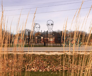 American Gothic sculpture through the grass outside the Public Library
