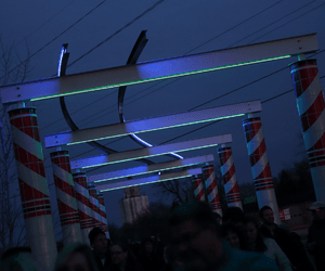 Night image of Railroad Pergola lit up at Raccoon River Valley Trail