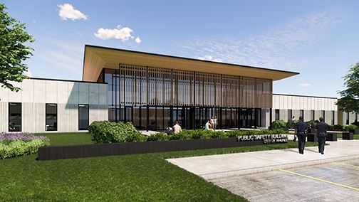 View of entrance with tall wall of windows and flat overhanging roof with people sitting outside