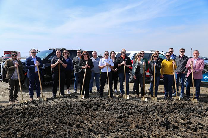 mayor, city council and project partners with shovels next to pile of dirt