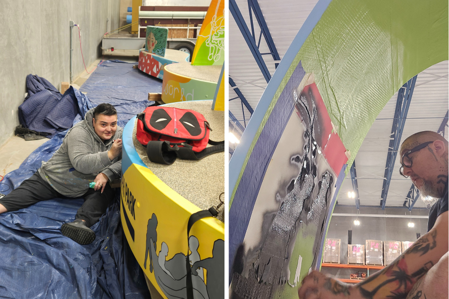 Artists painting details of sign language and children playing on a large bench